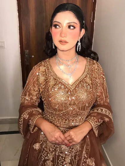 The full look is perfect for a sangeet or reception, combining tradition with modern glam.