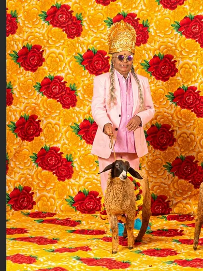 A striking image from my award-winning series, featuring my mother in a pink suit and crown, posing with a sheep against a floral backdrop.