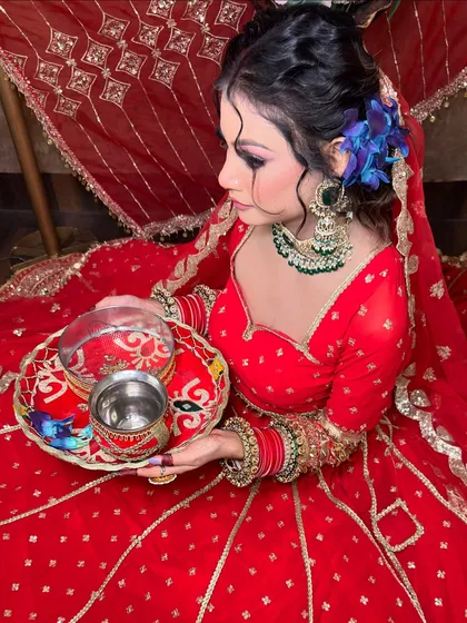 A closer look at the detailing on the red lehenga and the matching decorated thali. I can help you style your entire look for any festival.