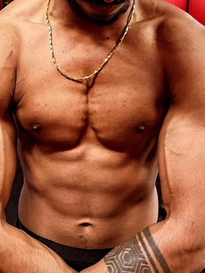 A close-up of the "after" physique, showcasing the newly built muscle mass in the chest and arms. This is the result of consistent training and proper nutrition.