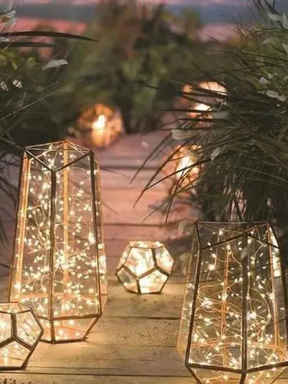 Geometric lanterns filled with twinkling lights create a modern and artistic lighting installation. I placed these along a garden path to guide guests and add a touch of contemporary elegance.