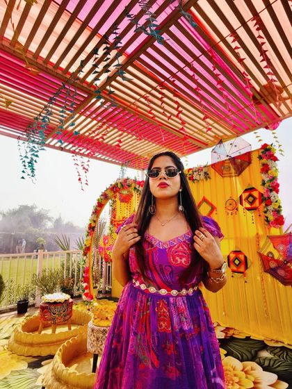 Posing against the vibrant Haldi decor before the guests arrive. I always match my outfit and energy to the theme of the event.