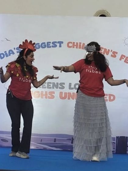 Two of our teachers in character, acting out a scene from our musical adaptation of "Rooster Raga." Their playful interaction and costumes help bring the story to life for the young audience.