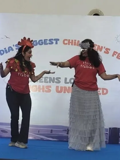 Two of our teachers in character, acting out a scene from our musical adaptation of "Rooster Raga." Their playful interaction and costumes help bring the story to life for the young audience.