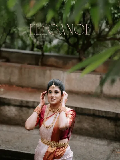 Elegance in every frame. A portrait of the bride in her classic white and red engagement saree, looking poised and beautiful.