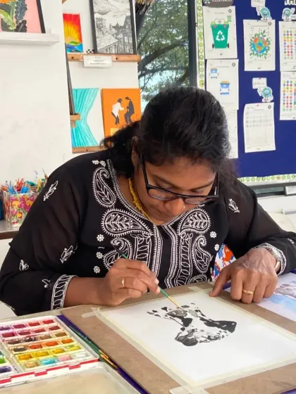 A student practices her watercolor techniques during a CFA session. The course balances guided instruction with hands-on practice.