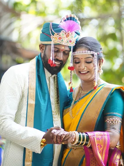 The couple holding hands, a symbol of their new beginning. The bride's makeup is radiant, reflecting the joy of the occasion.