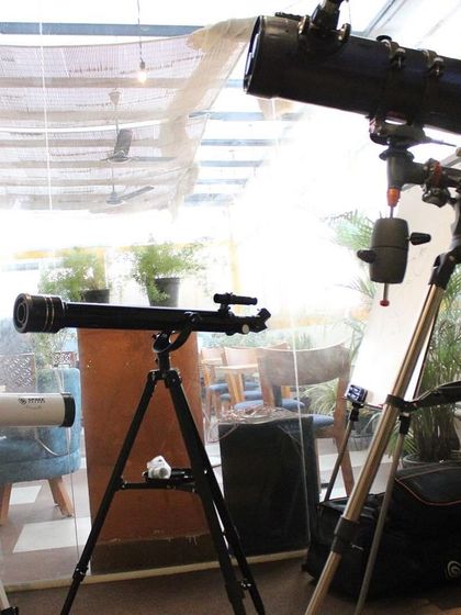 A collection of different telescopes set up in our cafe, ready for the exploration workshop.