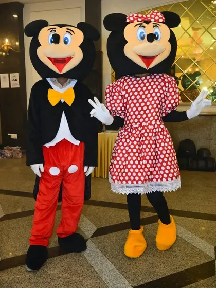 Mickey and Minnie Mouse posing for a photo. These characters bring so much joy and energy to a children's party.