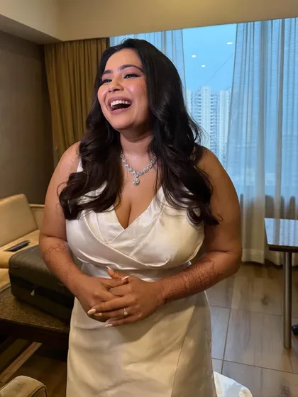A candid moment of laughter. The makeup looks natural and radiant, proving that you can have a full glam look that still feels like you.