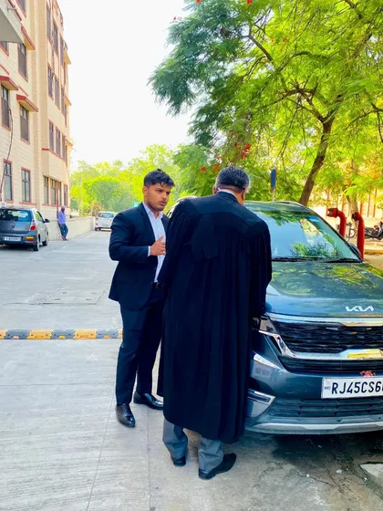 Discussing case strategy with a senior advocate outside the court. Collaboration and respect are key, but in the end, I aim to be the best.