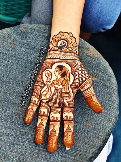 This intricate single-hand design features a 'solah shringar' theme, with a bride looking into a mirror. The details on the fingers include small elephant motifs, adding a traditional touch to the portrait work.