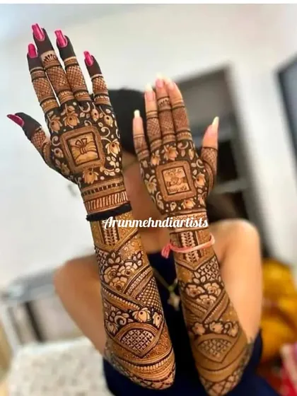 A unique bridal design with a focus on geometric patterns and elephant motifs in square panels. The arms feature a different, flowing pattern for a beautiful contrast.