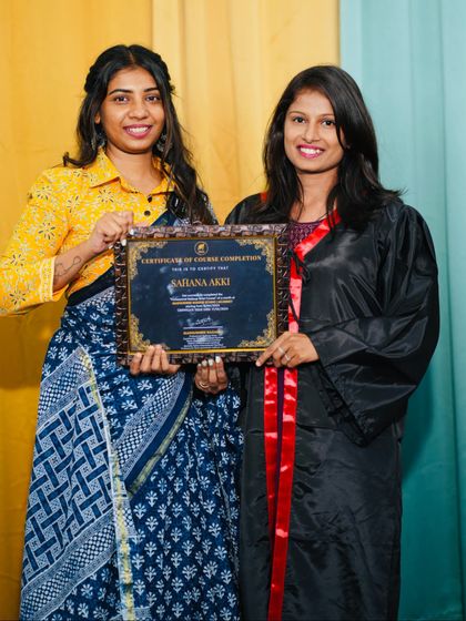 A proud moment with a graduate, holding her certificate of course completion.