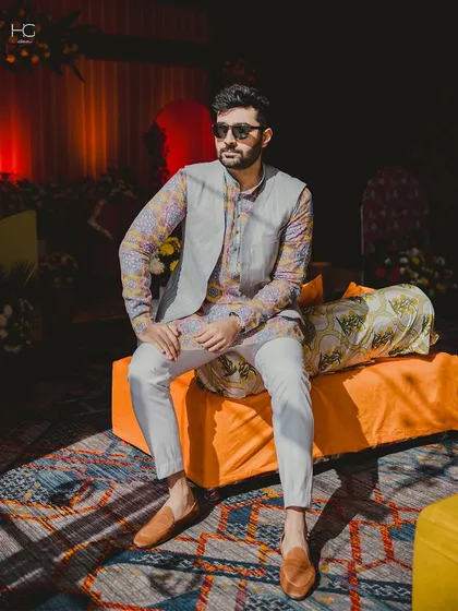 Capturing the relaxed yet dapper vibe for a daytime event. The sunglasses and confident posture complete this perfect festive season look.