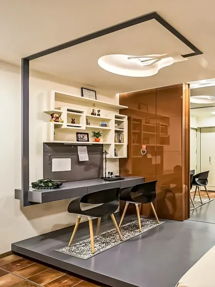 We used a raised platform to create a distinct and elevated study zone for two. This design choice visually separates the workspace from the rest of the room while adding a modern architectural element.