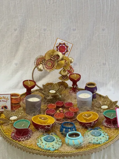A vibrant display of my handcrafted diyas and candle holders. I offer a wide variety of designs, from traditional painted terracotta to elegant peacock and lotus shapes, to light up every corner of your home.