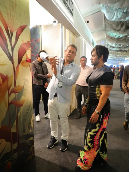 Sharing the stories behind our designs. Here, we are guiding Yash Birla through the details of a vibrant, large-scale floral wallcovering at our Ajio Luxe Weekend booth.