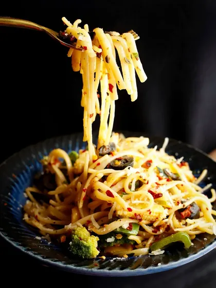 The classic noodle pull. This shot highlights the texture of the spaghetti and the delicious ingredients mixed within.