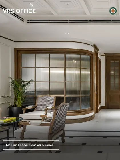 This graphic highlights the design philosophy of the VRS Office: a modern space with classical nuance. The image shows the curved glass wall and antique-style chairs, summarizing the project's successful blend of past and present.