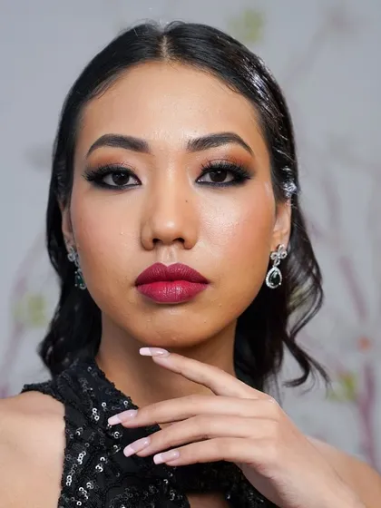 Confidence is the best accessory. Here, the combination of glowing skin, a bold lip, and dramatic lashes creates a powerful and unforgettable look, ready for any celebration.
