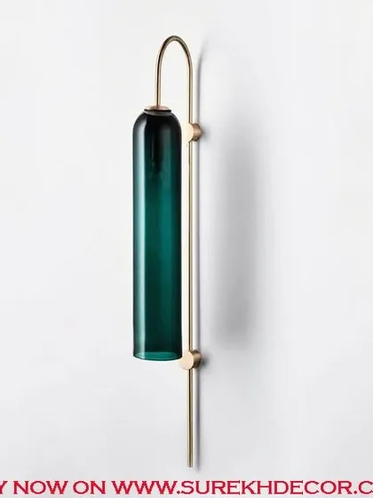 This elegant columnar wall lamp features an ocean blue glass shade on an antique brass fixture. The imported finish and tall, sleek design make it a stunning and colorful statement piece.