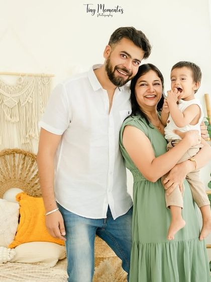 Laughter fills the studio in this candid family photo. The natural light and relaxed poses create a photo that feels authentic and full of life.