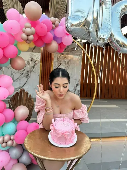 Making a wish! A close-up shot of the birthday girl and her cake, with our colorful balloon decor creating a beautiful, festive background.