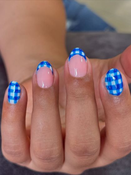 A fun, picnic-ready look with these hand-painted blue and white gingham French tips on short, natural nails.
