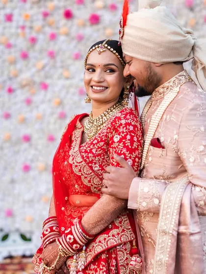 A sweet and candid moment. The groom whispering to his bride brings a genuine smile to her face.