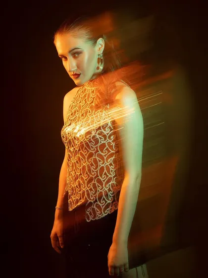 A full-body shot with the light trails creating a dynamic sweep across the image. This technique is all about experimenting and having fun in the studio.