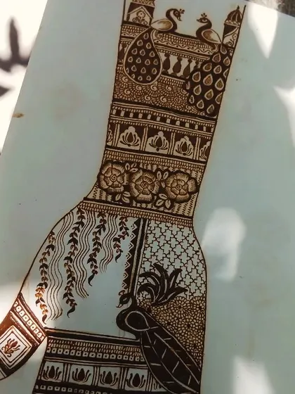A practice sheet showcasing a complex design that combines floral elements, peacock feathers, and different filler patterns. This demonstrates my design process.