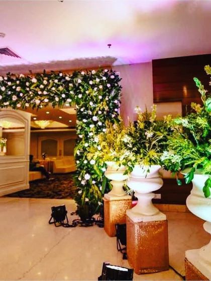 A classic floral arch at the entrance is always a beautiful choice. We created this lush arch with white flowers and greenery to provide a fresh and welcoming feel as guests entered the hall.