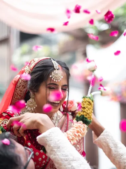 A shower of petals during the 'varmala' exchange, a moment of pure celebration.