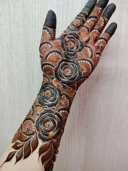 A stunning design featuring large, 3D black roses that stand out against the intricate brown background. This is a true statement piece.