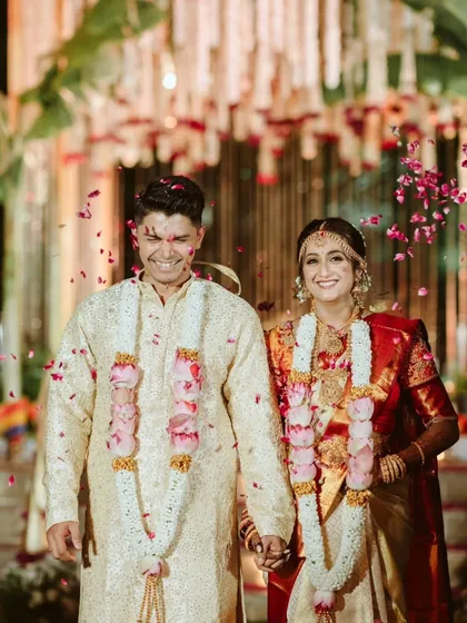 Pure joy and celebration as the couple is showered with petals after their ceremony. Their radiant smiles and the vibrant colors make this a perfect capture of wedding day happiness.