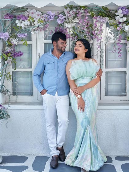 A picture-perfect pre-wedding moment at our studio's Santorini-themed setup. The bride-to-be wears our iridescent 'Snowflake' gown, which shimmers with pastel colors.