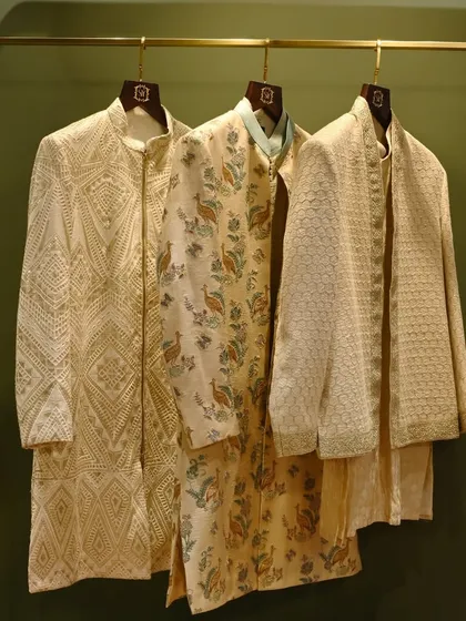 A trio of our ceremonial jackets, showcasing a range of styles from geometric patterns to floral prints and textured weaves. Each piece is designed to offer a distinct personality for any wedding event.