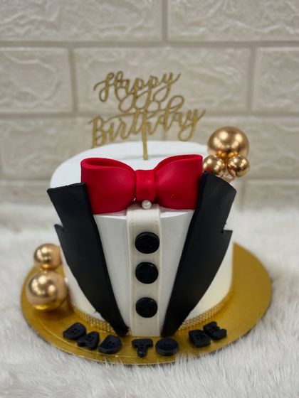 A dapper tuxedo cake for a "Dad to be." This elegant design with a red bow tie is a classy way to celebrate the new chapter in his life.