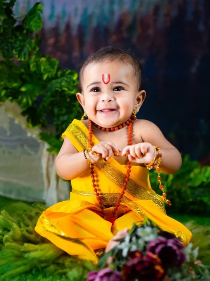 A close-up of a happy little Sri Rama. His bright smile and traditional attire make for an unforgettable portrait.