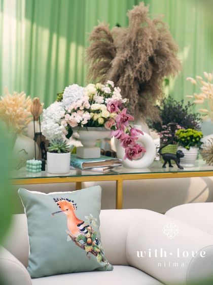 A close-up of the custom cushions and floral arrangements in 'The Conservatory' lounge area.