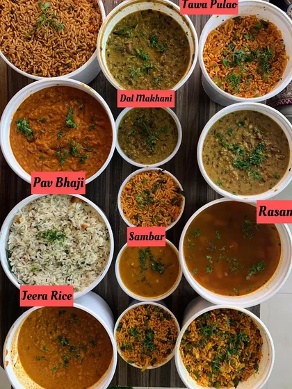 A variety of main course dishes including Tawa Pulao, Dal Makhani, Pav Bhaji, Sambar, Rasam, and Jeera Rice.
