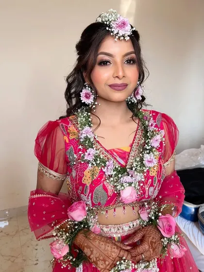 The complete Haldi look, with the bride adorned in beautiful floral jewelry. She looks happy, fresh, and ready for the celebrations to begin.