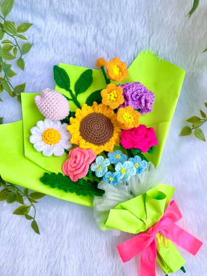 The vibrant bouquet resting on a soft white background, showing off its bright colors and cheerful arrangement.