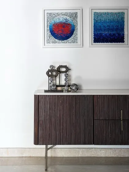 Our fluted wood console with a marble top, perfectly styled in a client's home by Aurora Studio. The clean lines of the console provide a beautiful contrast to the textured artwork and accessories.