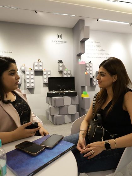 A focused discussion between two women at a booth, highlighting the diverse and inclusive professional community that attends our expo.