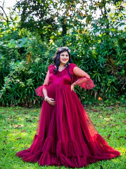 This mom-to-be looks lovely in a ruffled magenta gown, complete with a flower crown, for her garden maternity session.