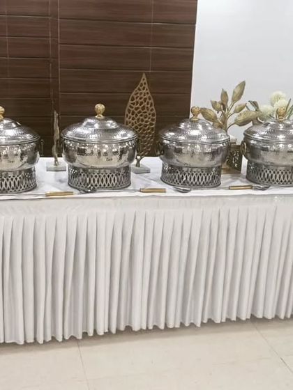 A clean and classic white-themed buffet setup for a corporate event of 70 guests in Sector 57, Gurgaon. This minimalist approach is both professional and elegant.