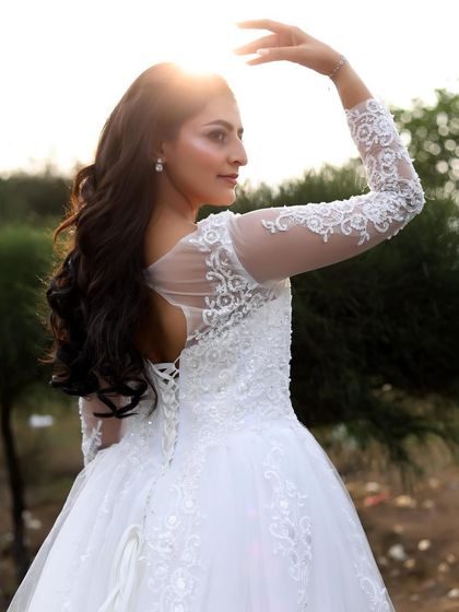 A side profile of the woman in the white gown, with the sun creating a beautiful halo effect.