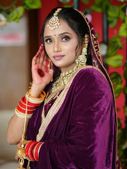 Another angle of this beautiful bride, showing how the glossy red nails stand out against the deep purple of her outfit and the gold of her jewelry.